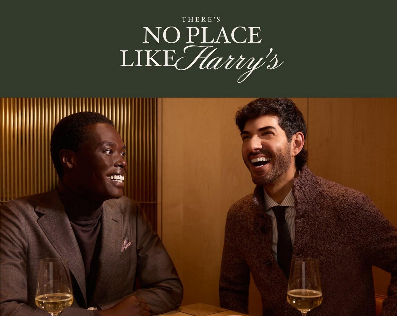 Two men in tailored suits enjoying a conversation over wine at a restaurant, with the text “There’s No Place Like Harry’s