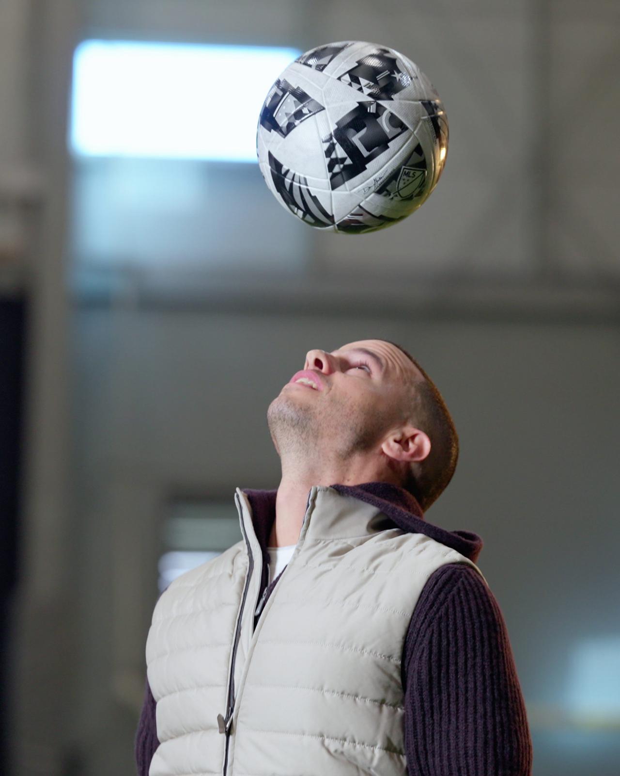 Sebastian Giovinco wearing a vest and playing with football