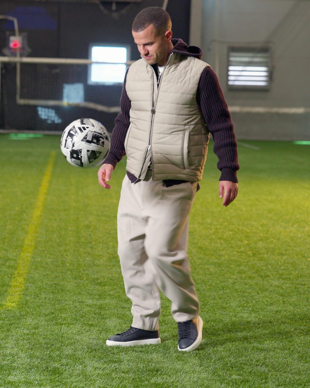 Sebastian Giovinco wearing a vest and playing with football