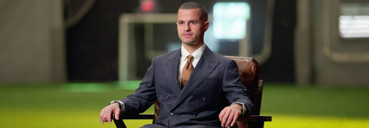 Sebastian Giovinco in a suit seated in an armchair