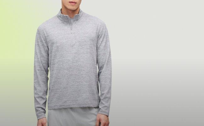 Homme portant un chandail demi-zip gris chiné et un short athlétique gris de Reigning Champ, collection A/H26