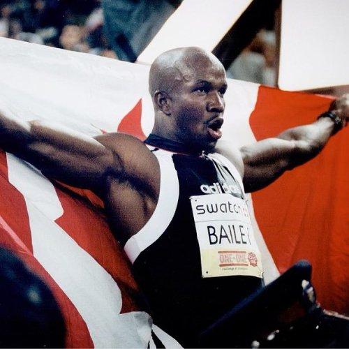 Donovan Bailey, le plus grand athlète canadien, tenant le drapeau du Canada