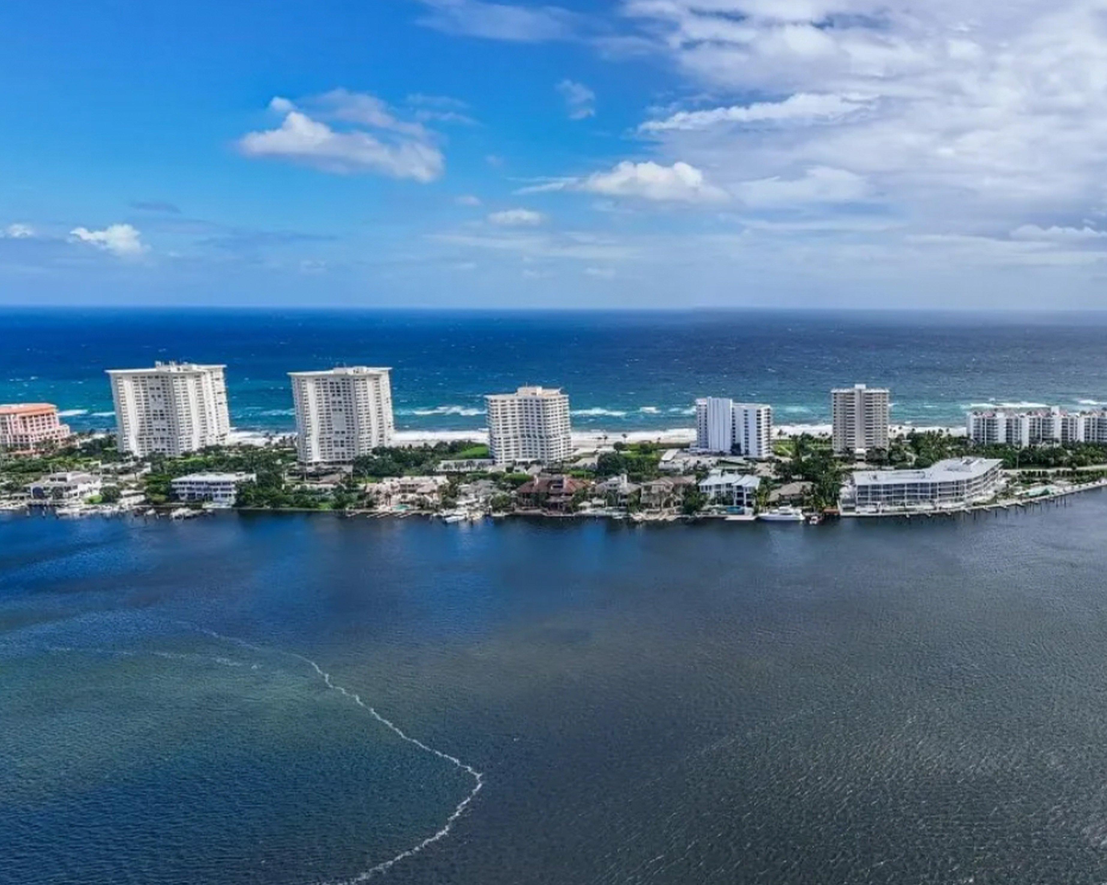 An aerial view of the ocean and buildings near the water