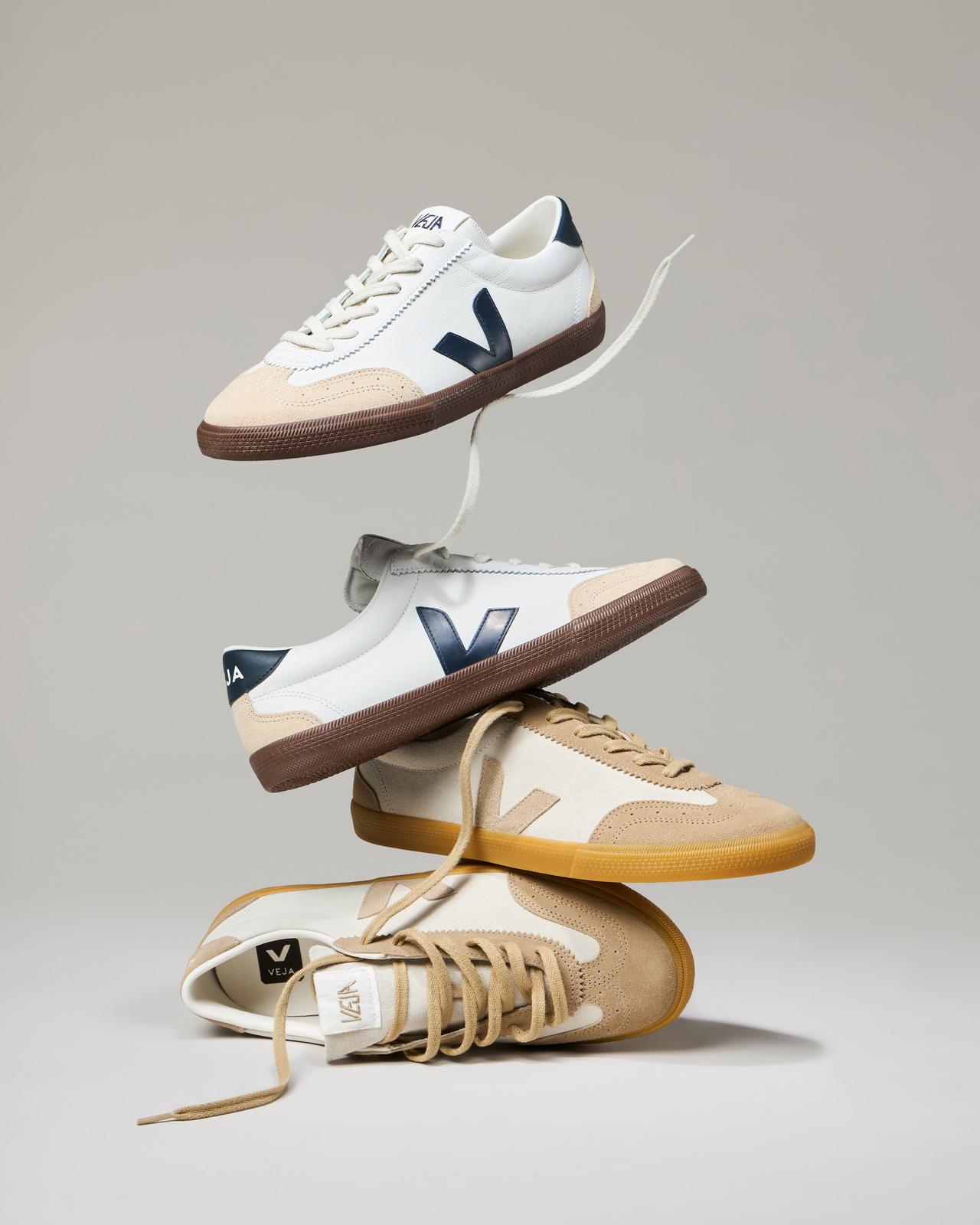 Four pairs of VEJA sneakers stacked on top of each other
