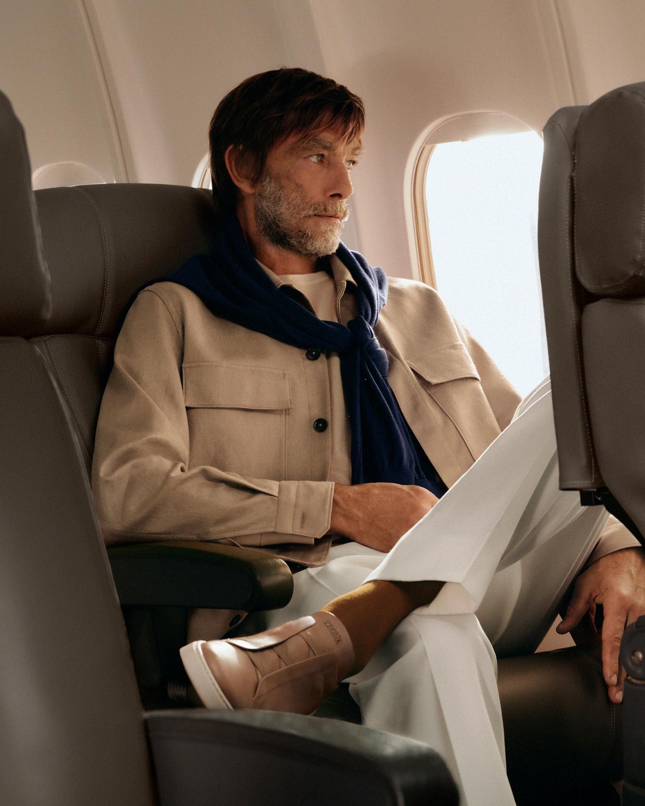 Man on a plane wearing Zegna