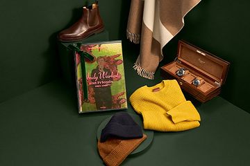 Zegna yellow sweater, two toques, two watches, brown chelsea boot, scarf, and Taschen coffee table book