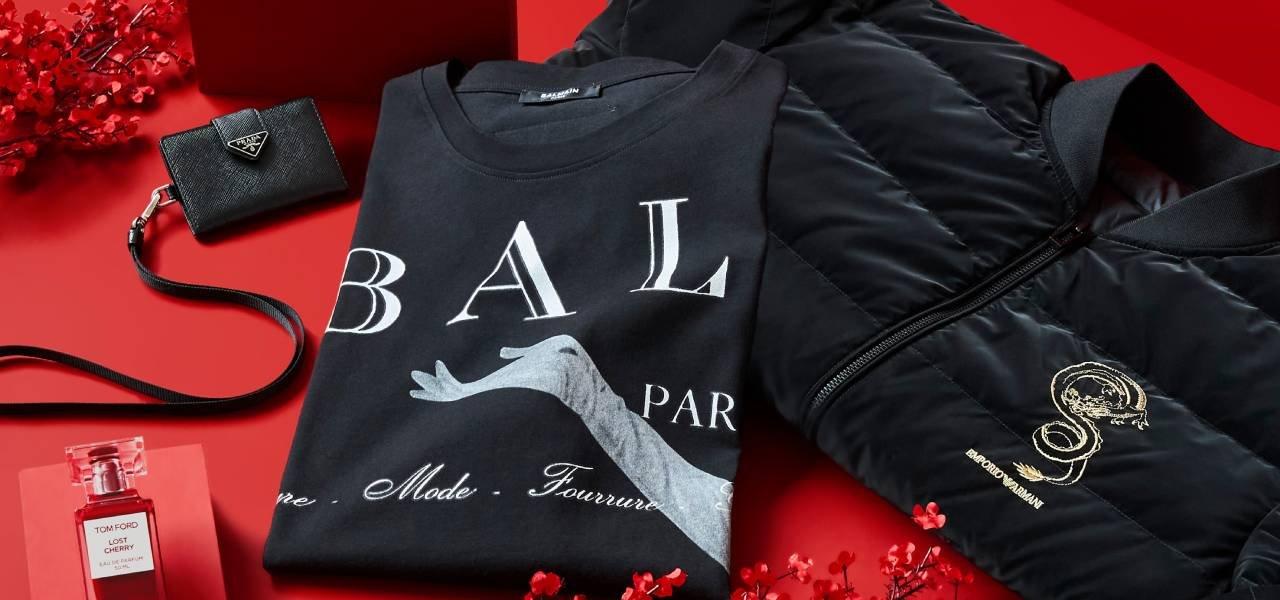 A red and black jacket, a red purse, and a red bottle of perfume