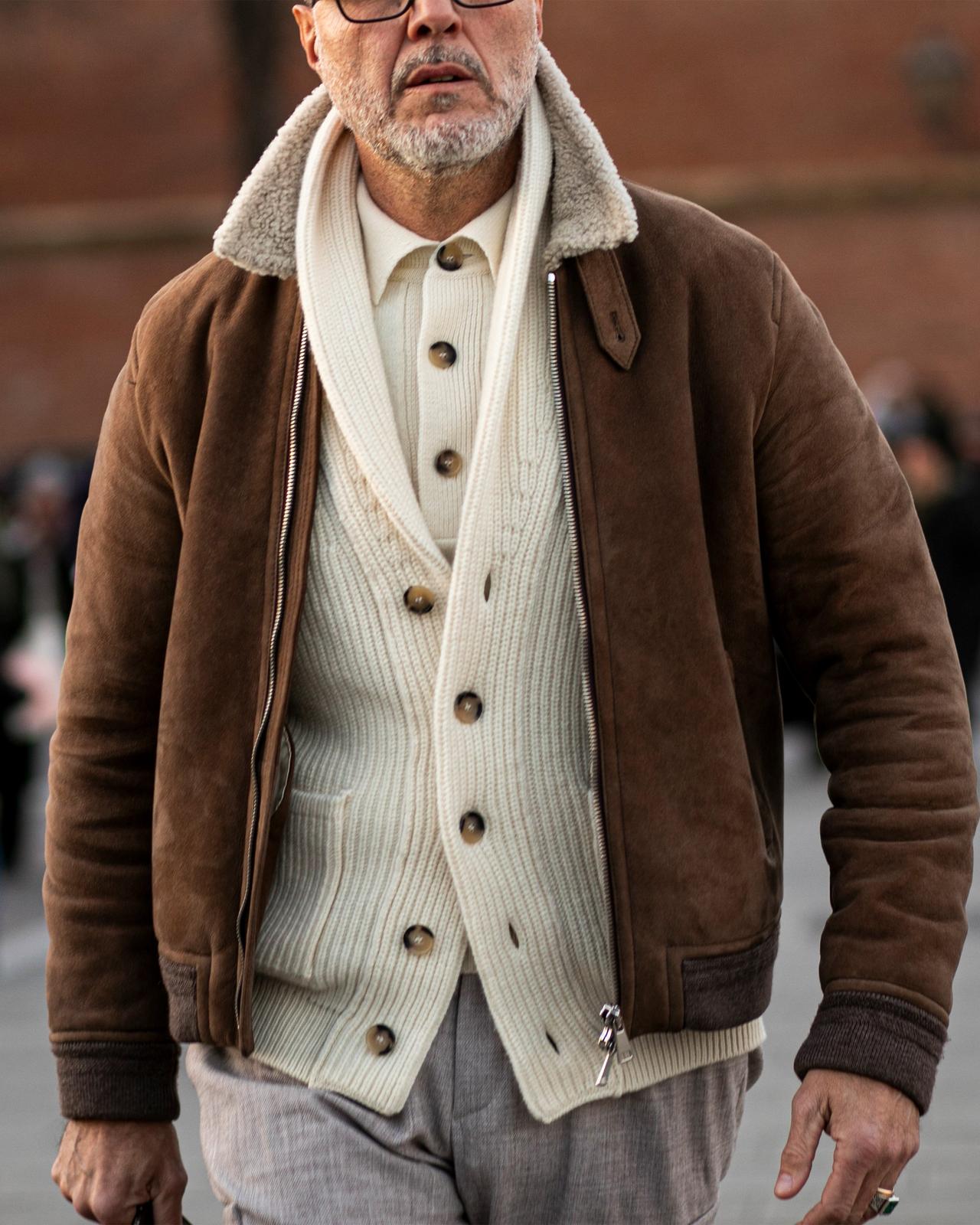 Male wearing layered look in beige and cream