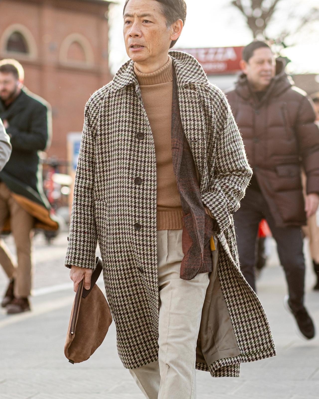 Male wearing layered look in beige and cream