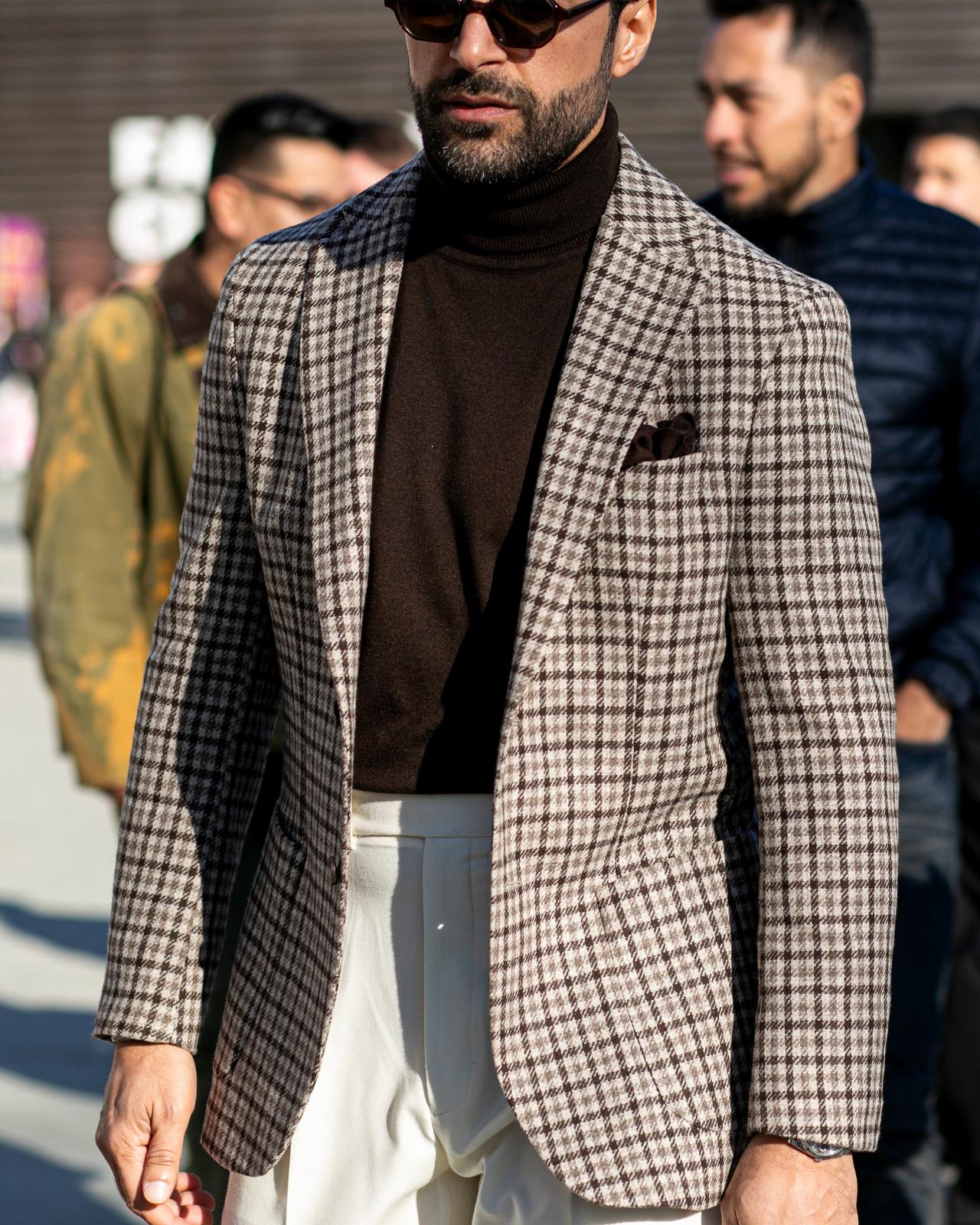 Male wearing layered look in beige and cream