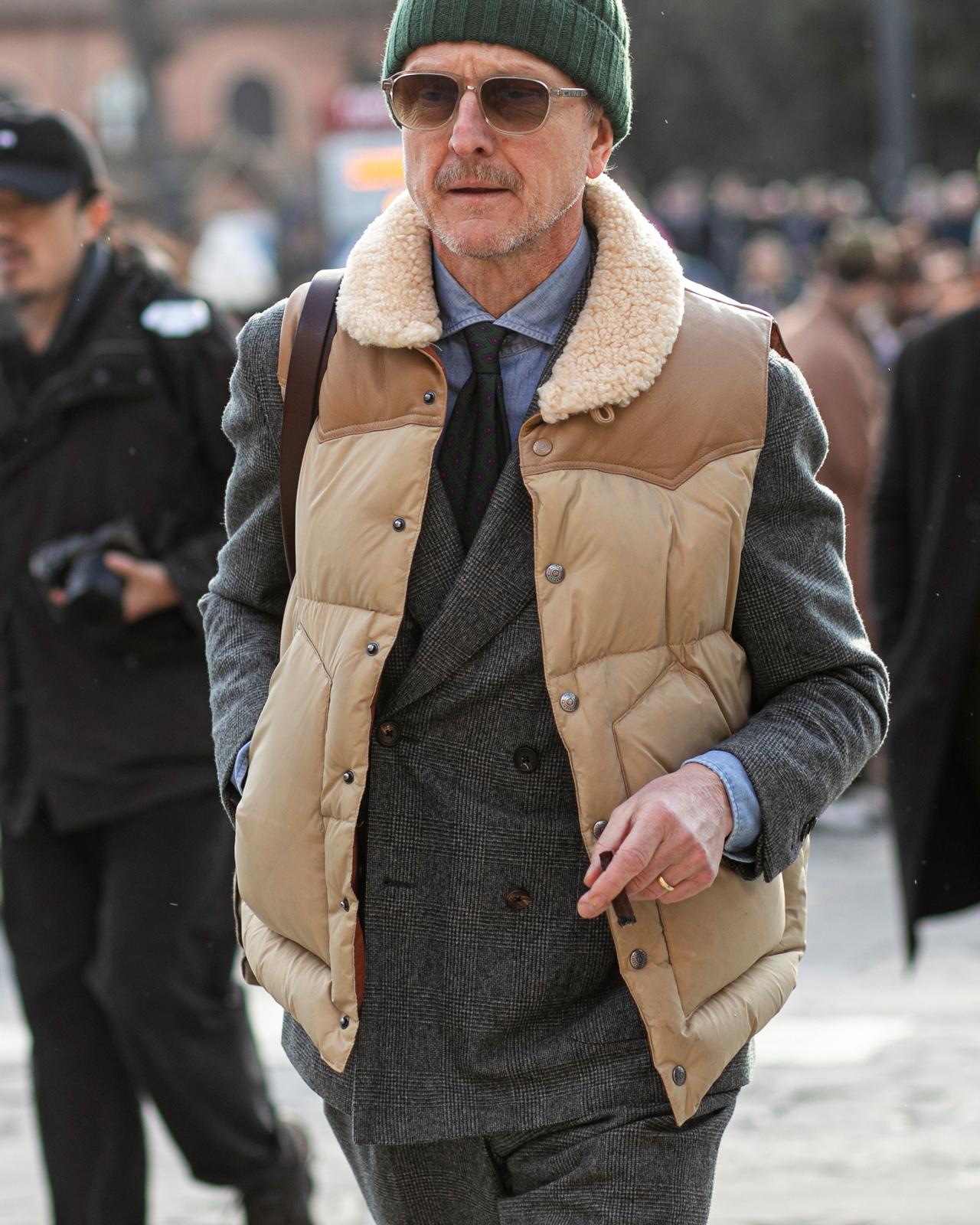 Man wearing layered outfit look with vibrant tie