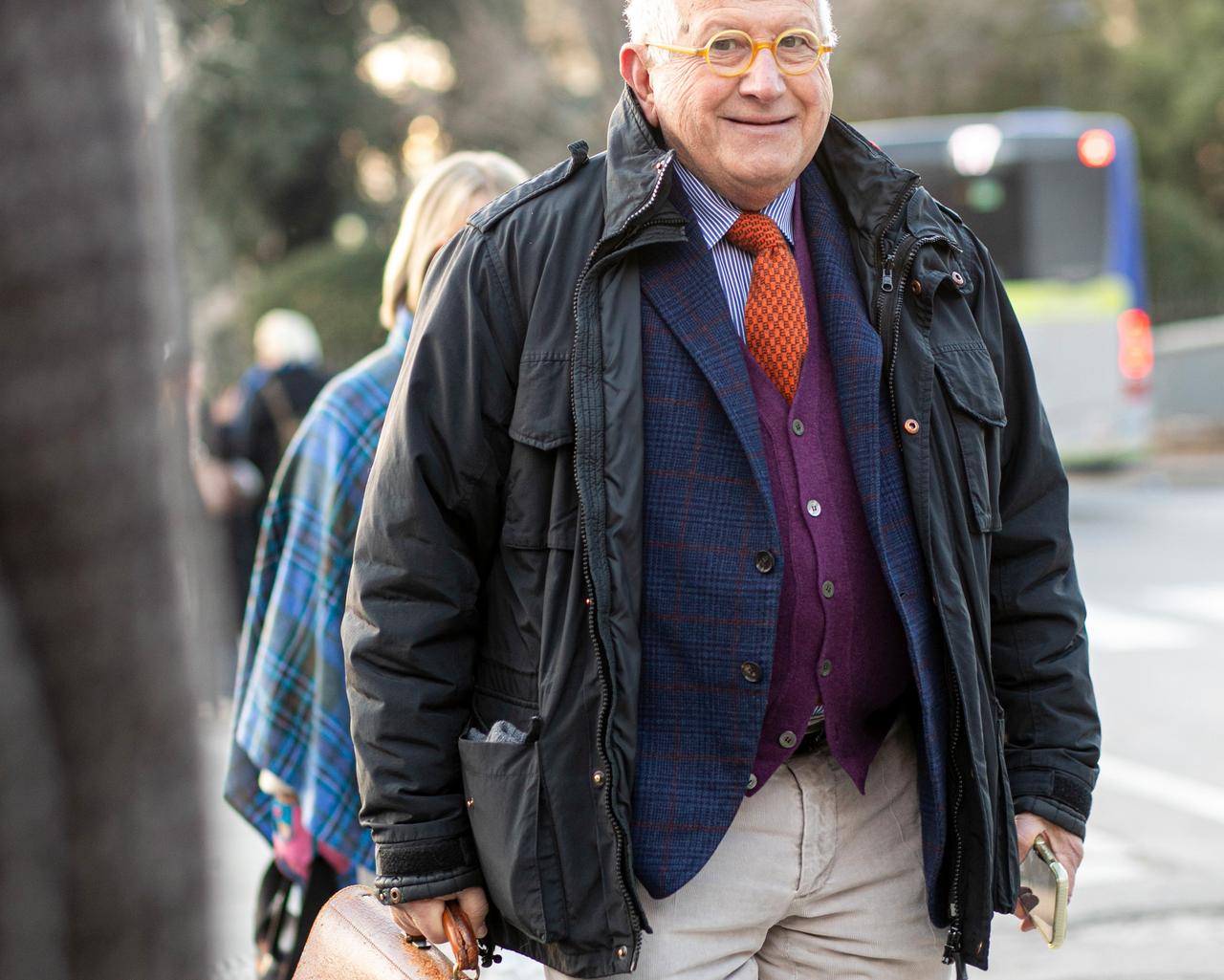 Man wearing layered outfit look with vibrant tie