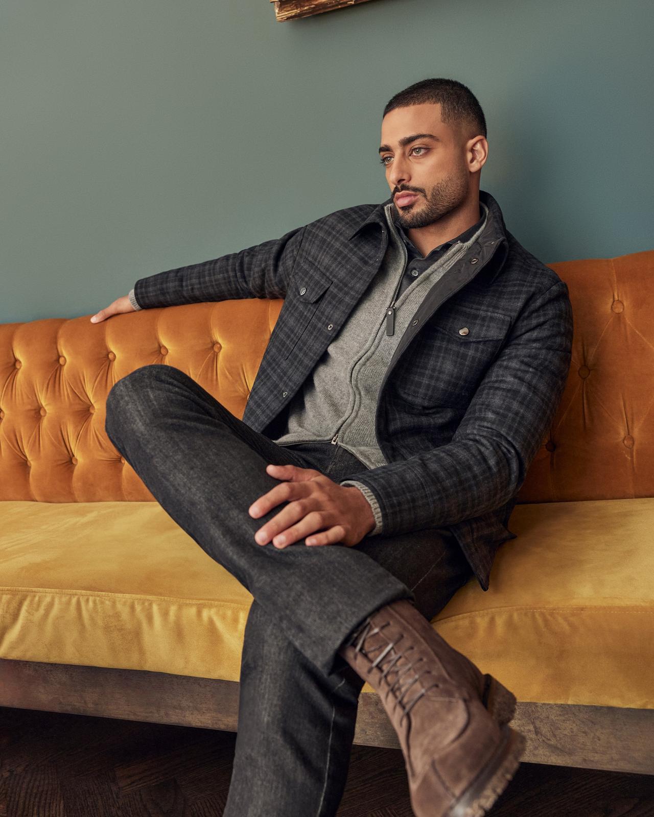 Male model sitting on couch wearing Canali illustrating 'fw24 style