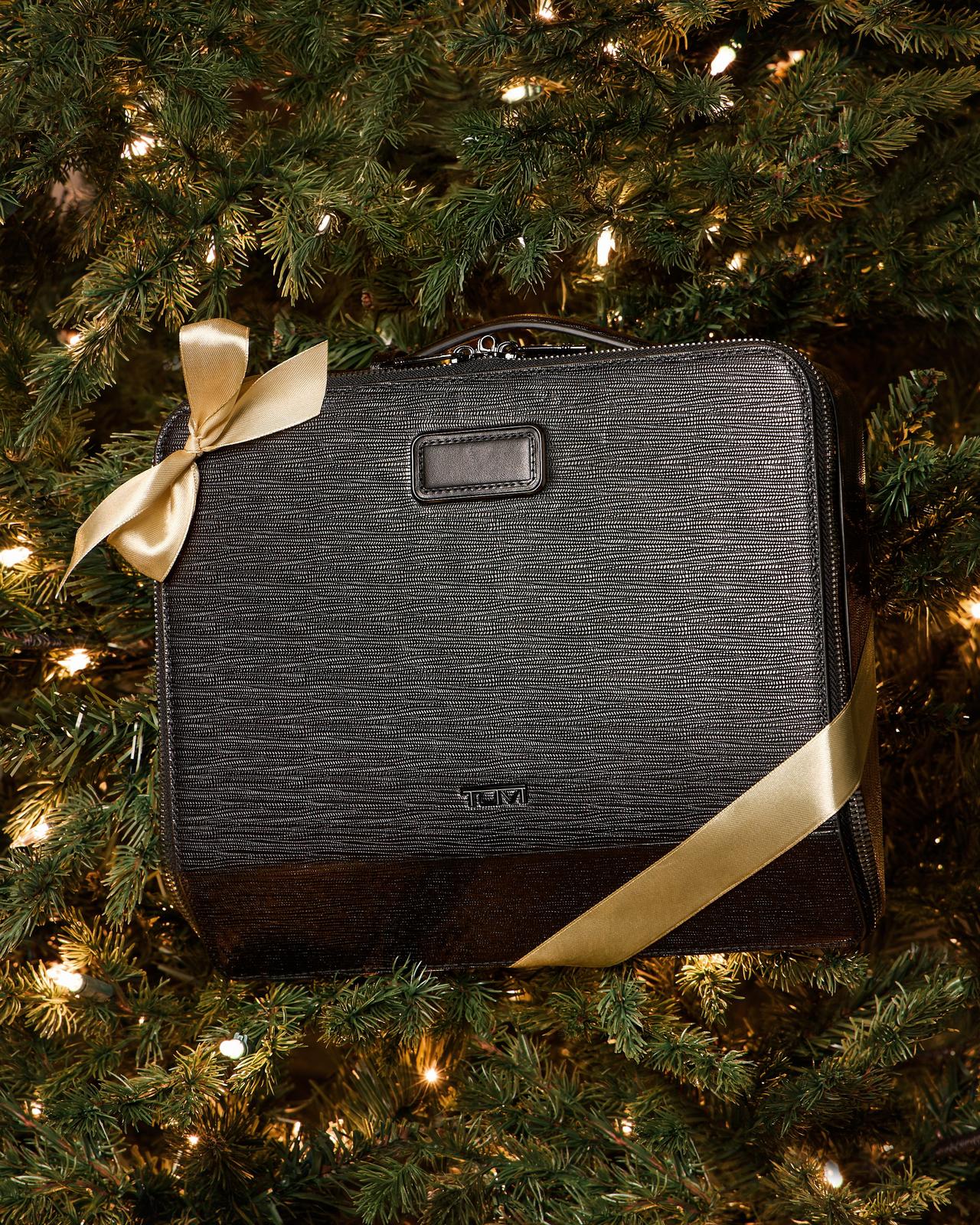 A black suitcase gift wrapped with a ribbon