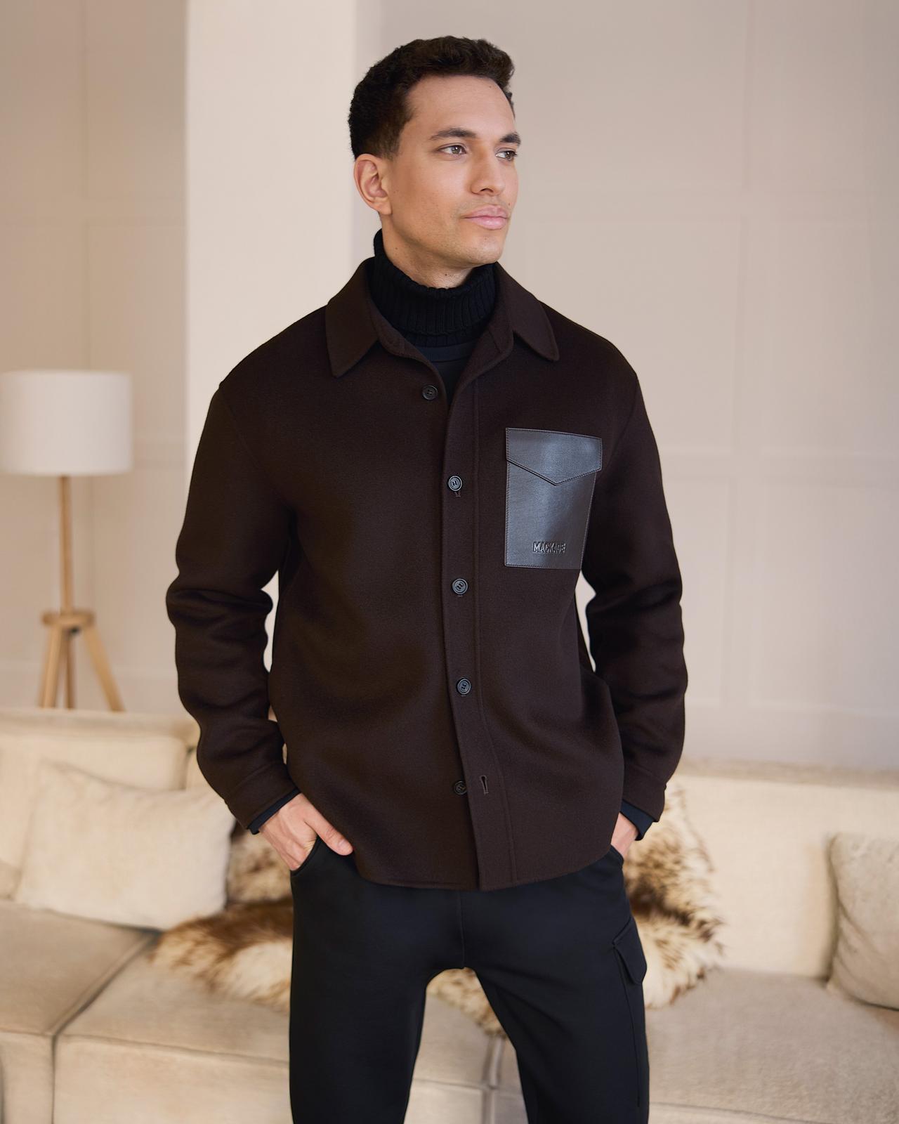 A male model wearing a dark brown Mackage wool overshirt and black trousers
