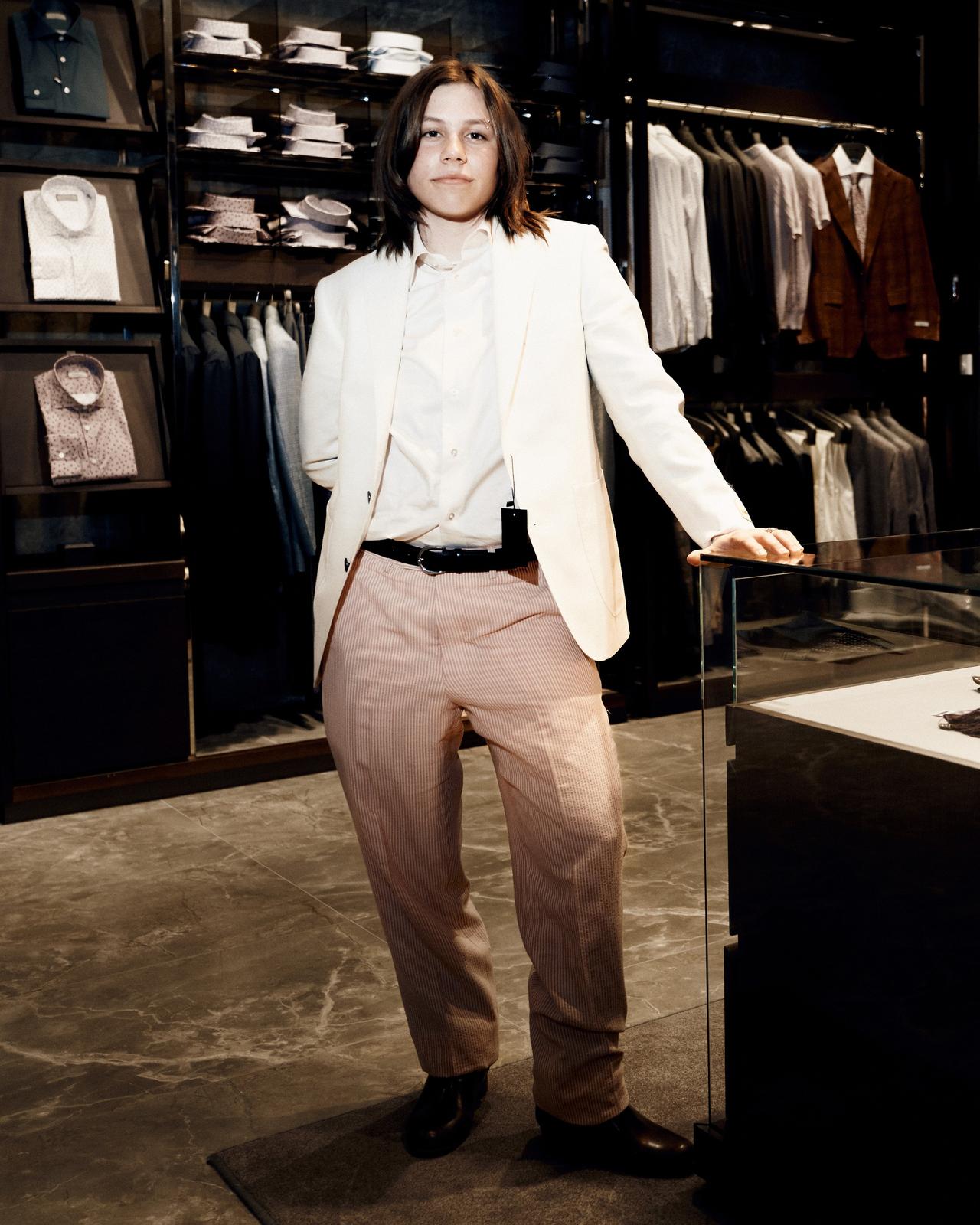 a person in a white suit standing in a room