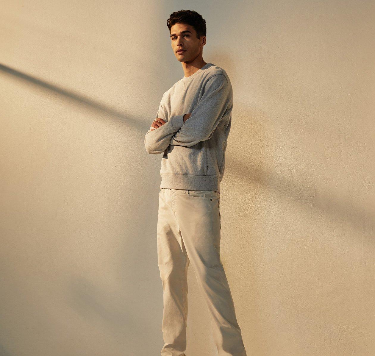 male model wearing AG jeans and sweater