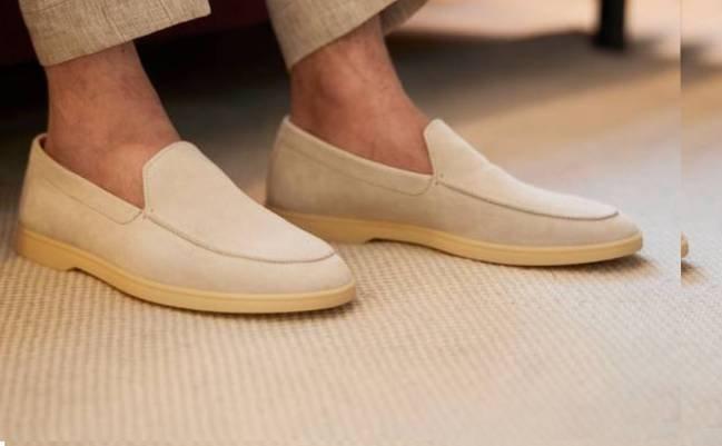 Male model wearing a pair of cream Henderson loafers