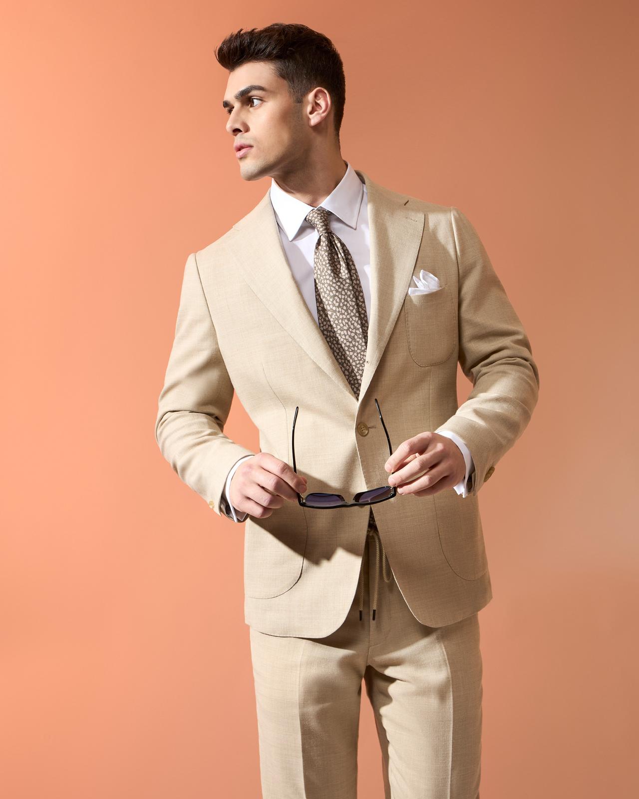 Male model wearing Harold made-to-measure cream linen suit