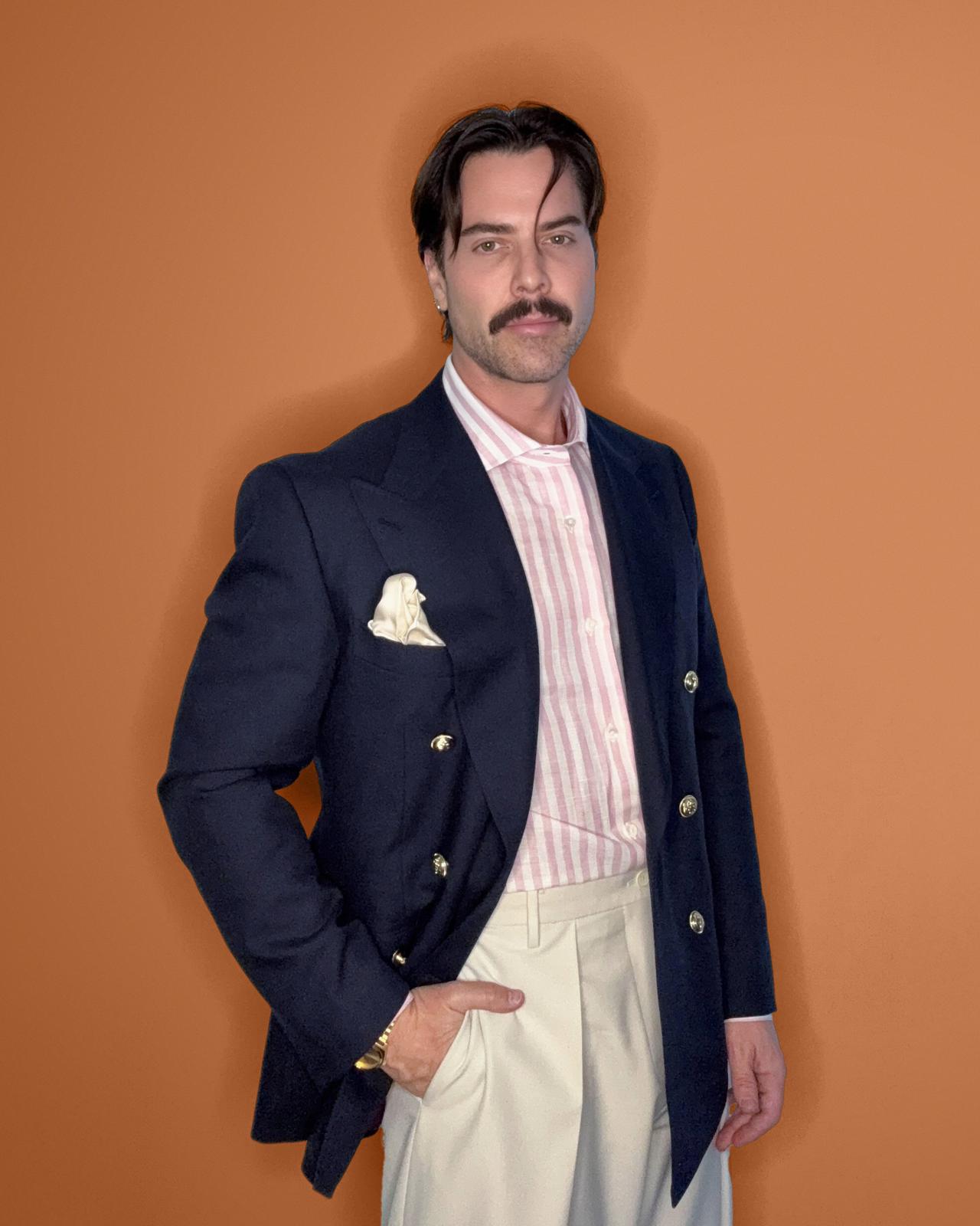Derrick Branco on a coloured orange background