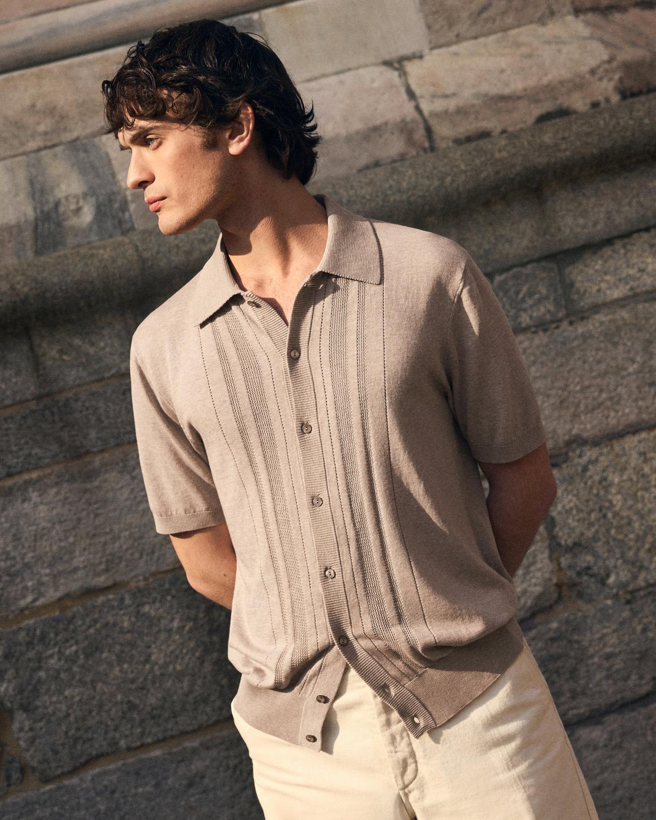 A man wearing a multicolored floral print shirt
