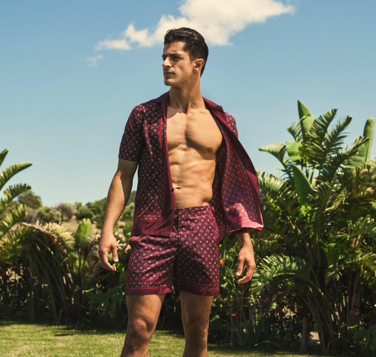 A man wearing a reddish brown shirt and shorts