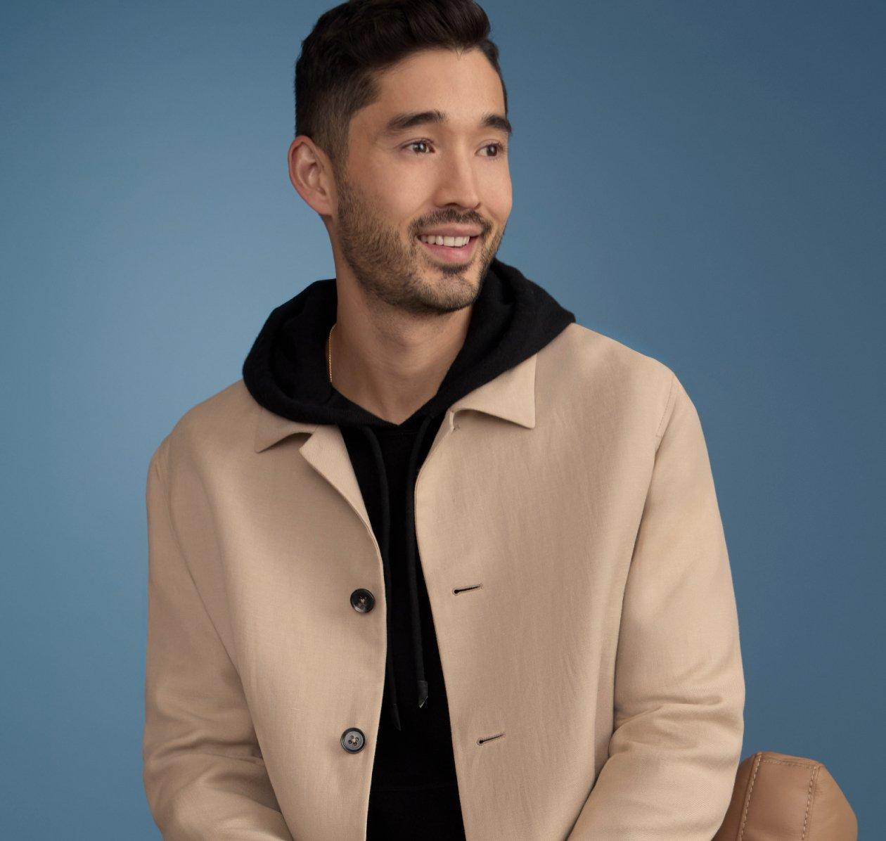 Man dressed in a white button-down shirt styled with a blue tie