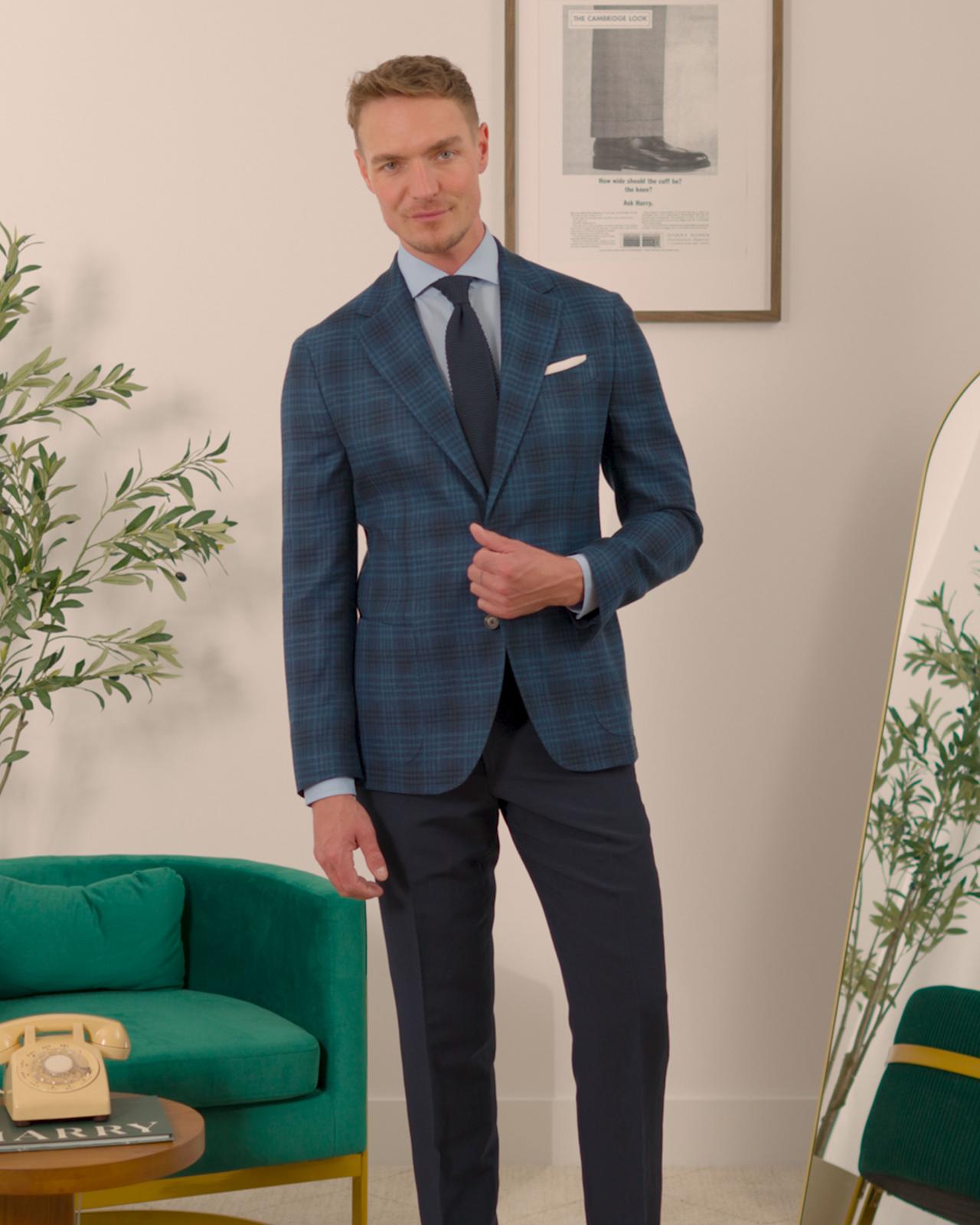 Male model wearing a navy check sport jacket
