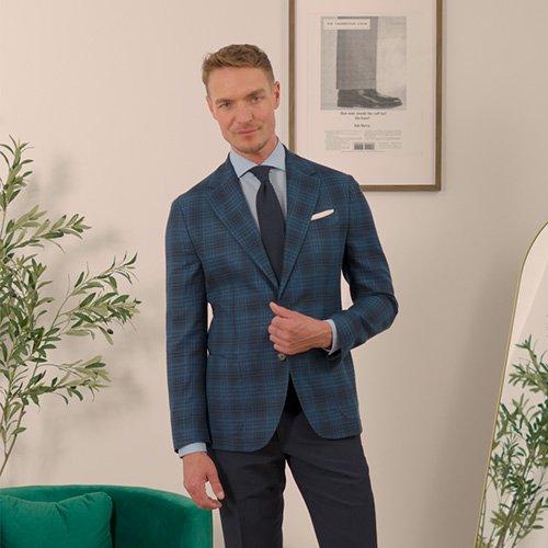 Male model wearing a navy check sport jacket