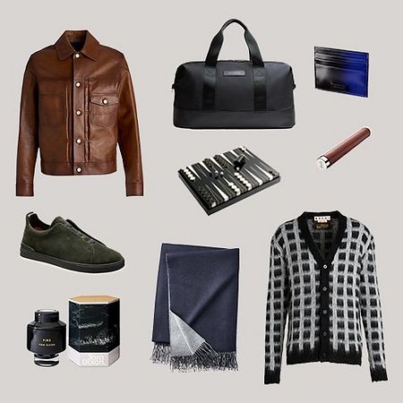 Scattered display of gift ideas: Off body brown leather jacket, black and white cardigan, throw, workbag, shoes, scented candle, and cardholder.