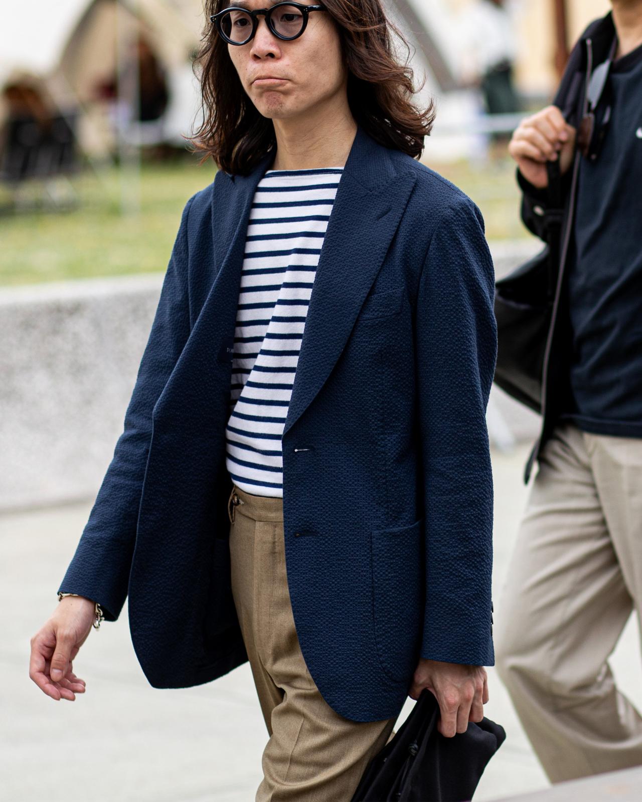 a woman walking down the street with a black bag
