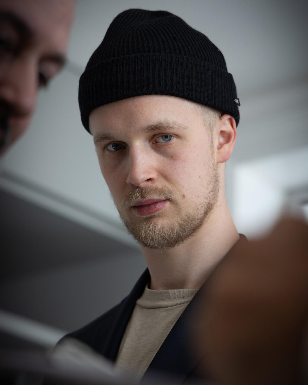 A man with a black beanie and a man with a beard