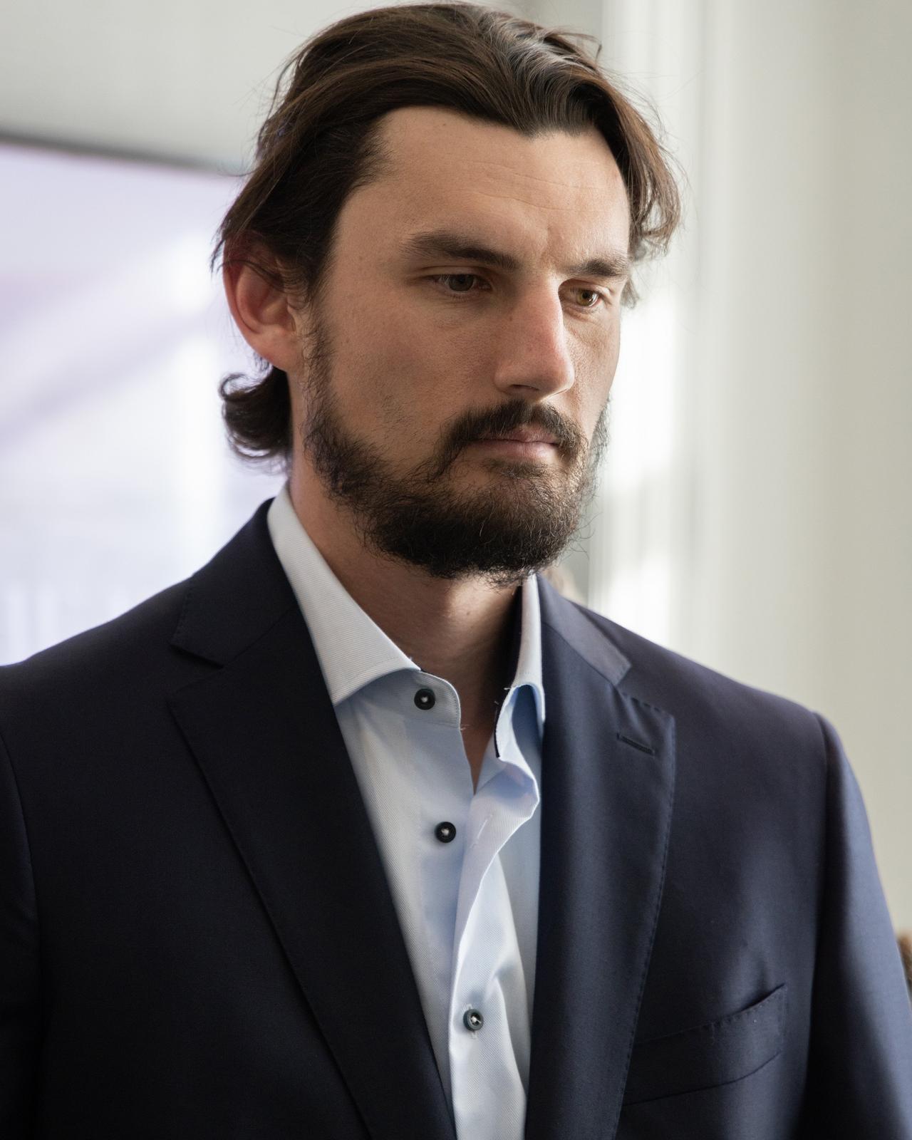 A man in a suit and tie looking at something