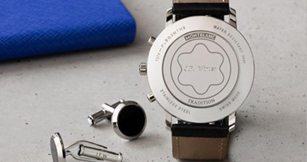 the back of a watch and cuff links on a table