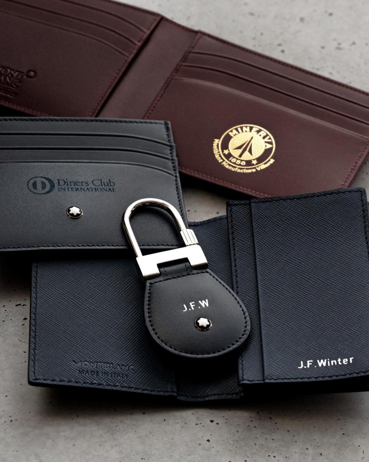 a wallet with a key attached to it sitting on a table