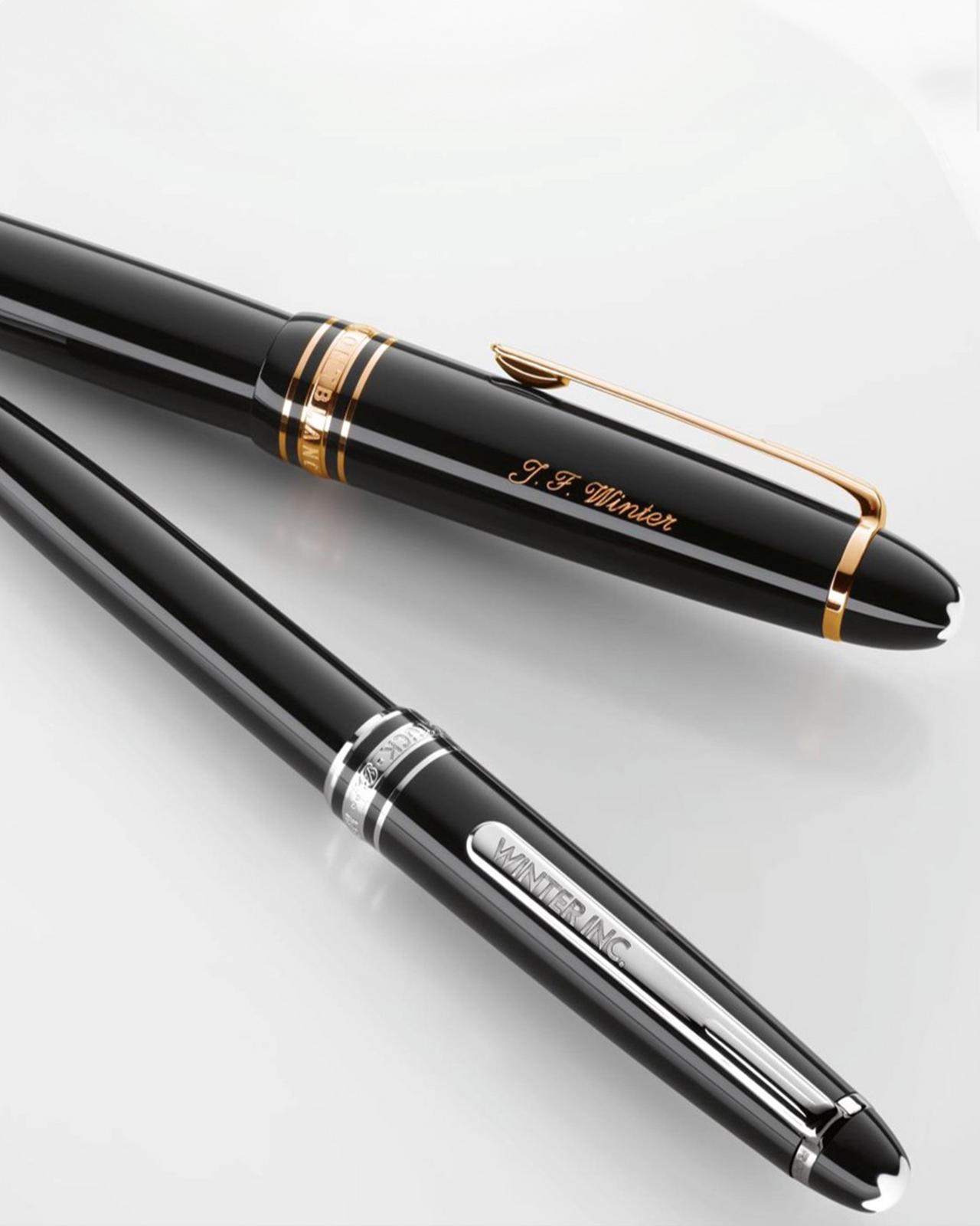 two pens laying side by side on a white surface