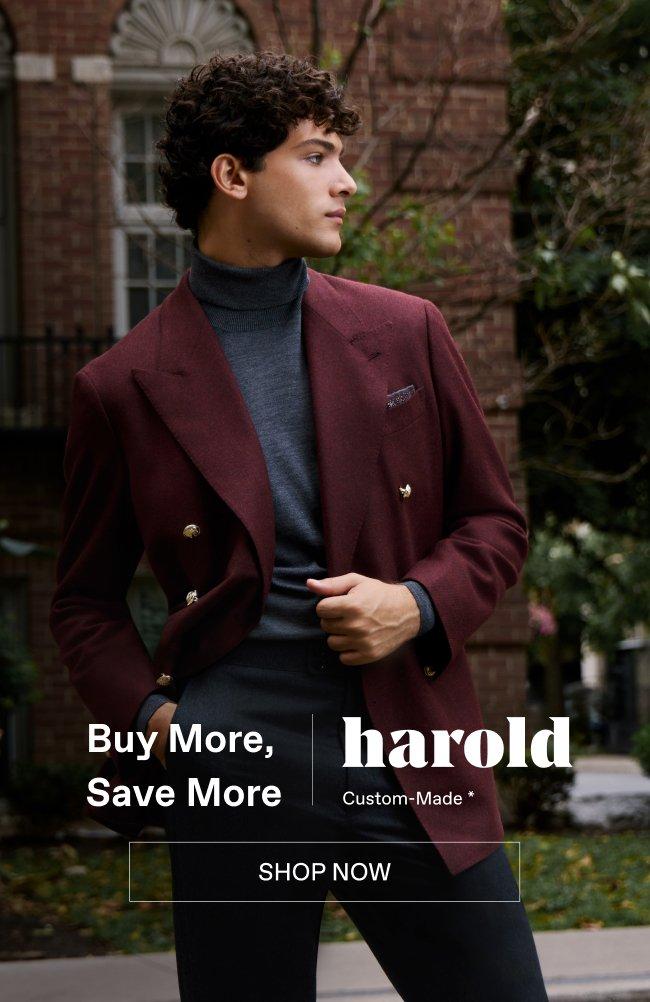 fashion model wearing burgundy blazer with a dark turtleneck and tailored trousers
