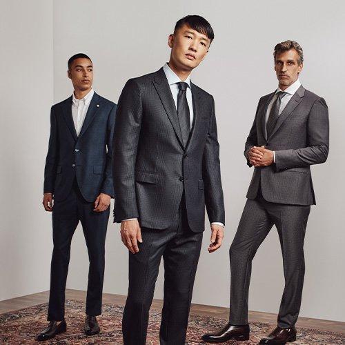 Three male models wearing suits