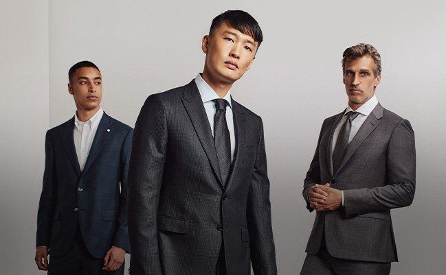 Three male models wearing suits