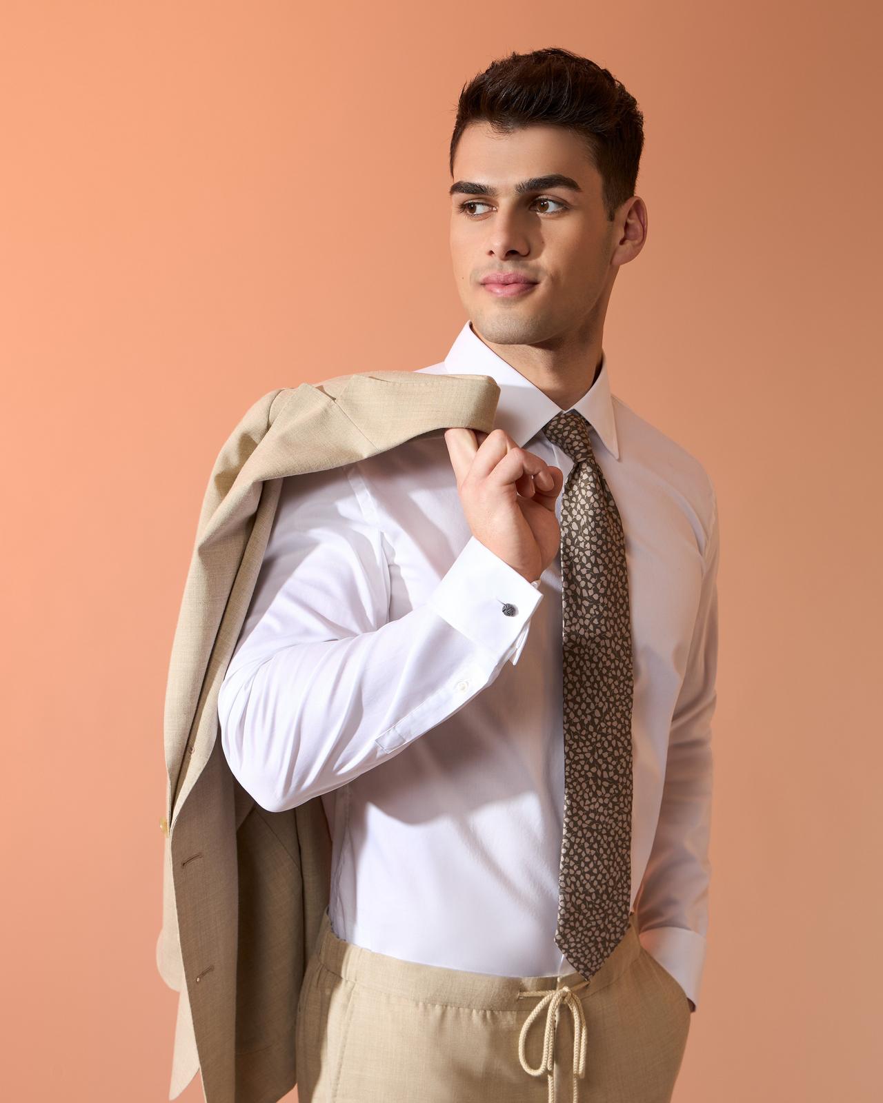 Male model wearing a white dress shirt and beige sport jacket
