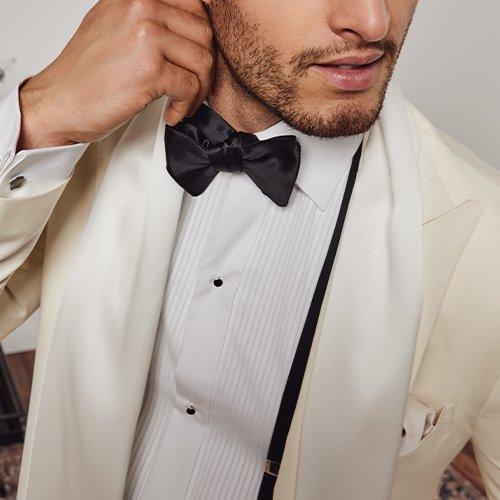 Male wearing tuxedo and bow tie signifying wedding trends for 2025