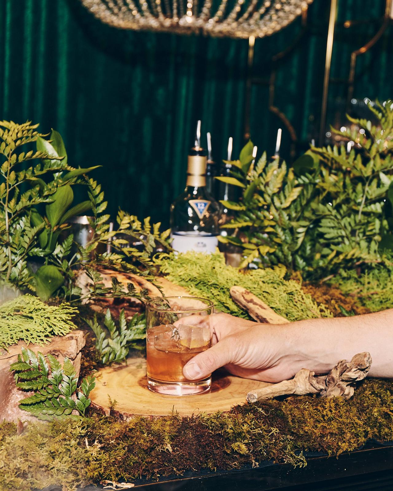 A person holding a glass of whisky