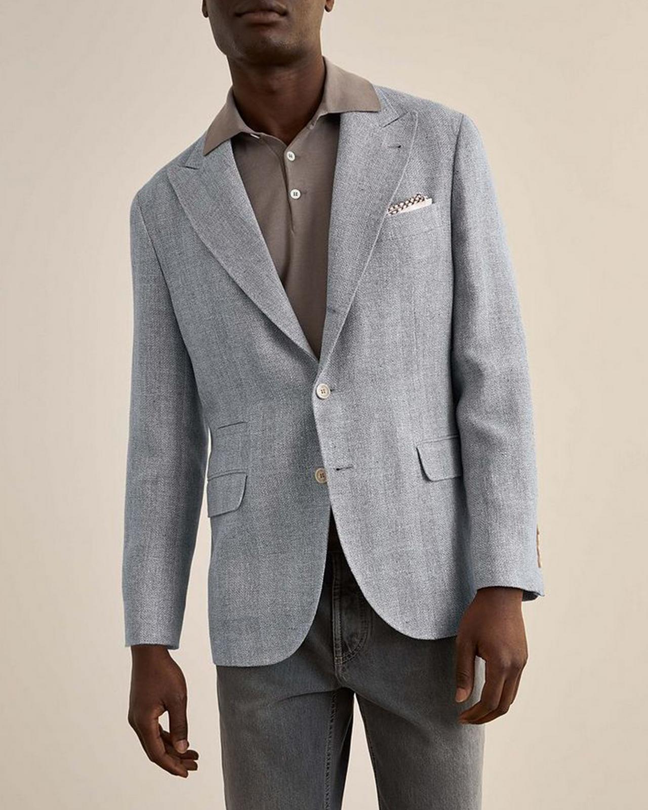 Male model wear a linen blue sport jacket by Brunello Cucinelli