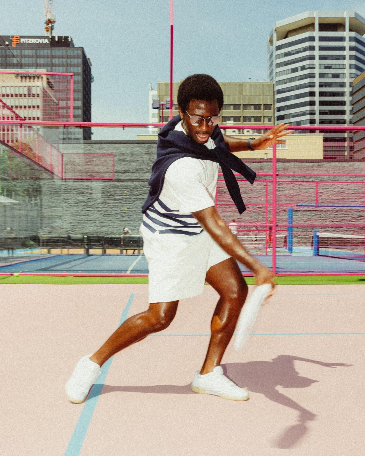 Man playing pickleball in sporty summer attire