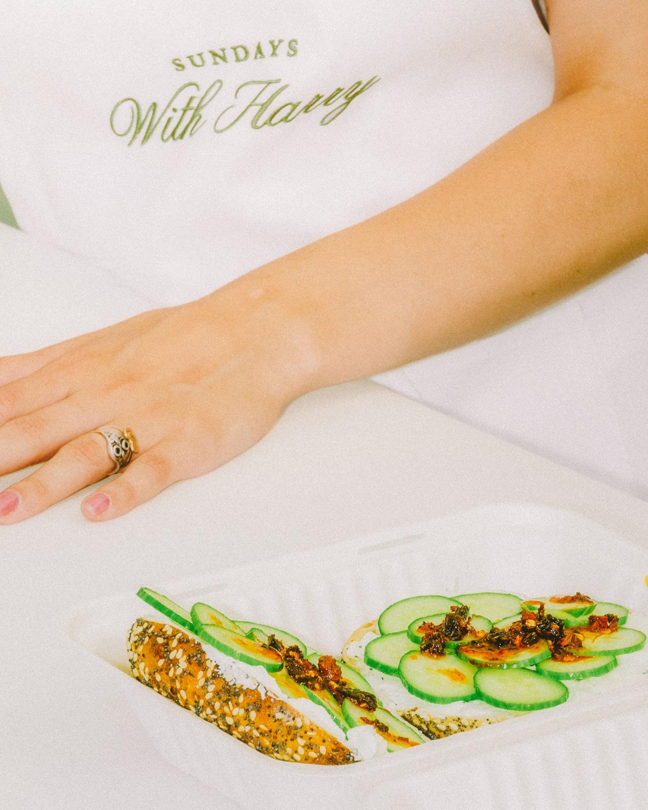 A tray with toast topped with fresh cucumber slices and tasty toppings