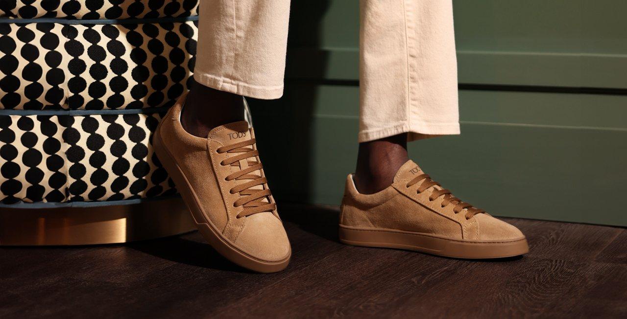 Male wearing Tods sneakers