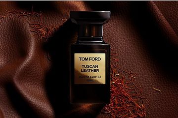 Image 25: A bottle of Tom Ford Tuscan Leather perfume placed on a brown textured fabric