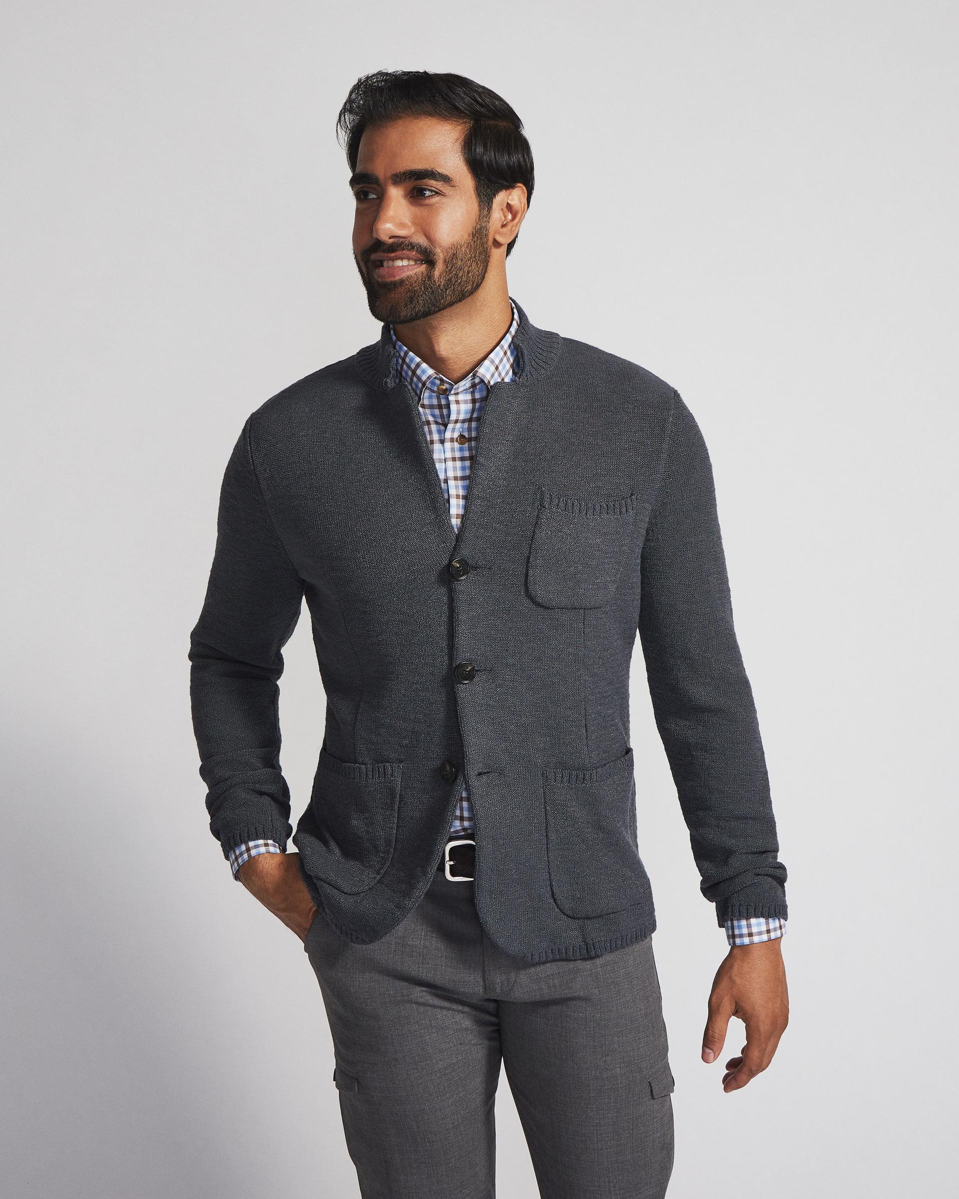 Male model wearing cardigan sweater signifying up to 60% off sweaters and knits