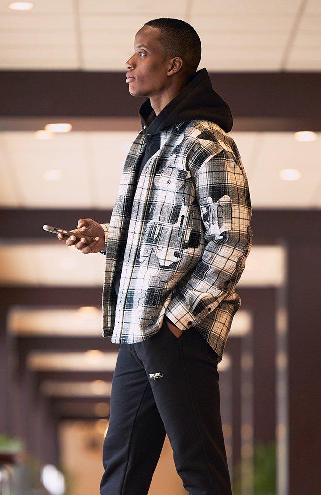 Male model wearing Purple Brand shirt signifying what is grid core?