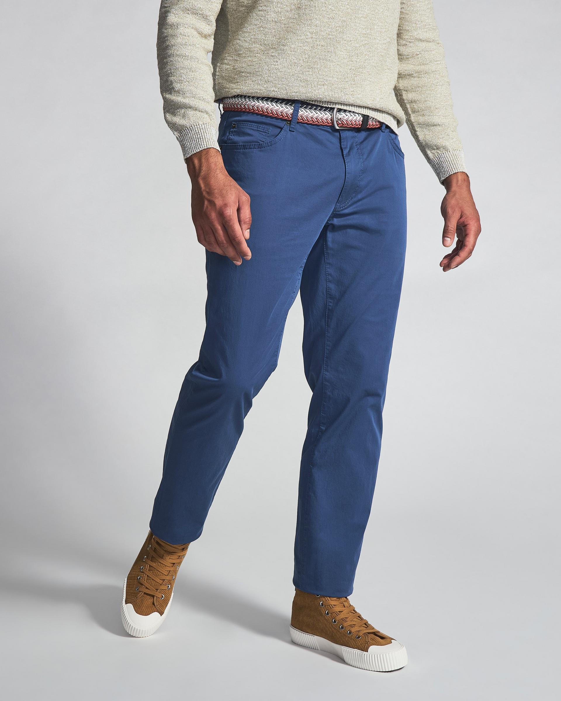 Male model wearing coloured denim signifying Paige and Brax styles starting at $124.99